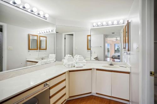 a bathroom with two sinks and a large mirror at Land's End 5-303 Gulf-Bay Front in St Pete Beach