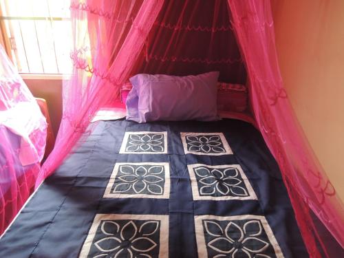 En eller flere senge i et værelse på Bunyong Homestay