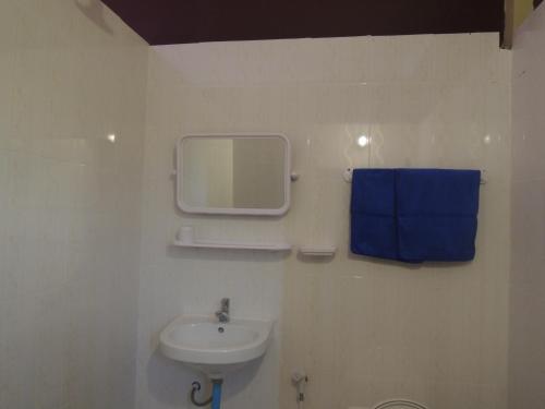 a bathroom with a sink and a mirror on the wall at Bunyong Homestay in Siem Reap