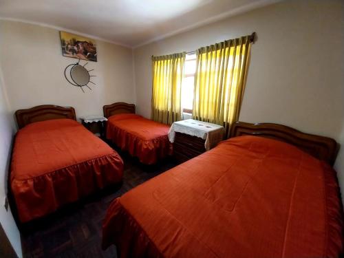 a hotel room with two beds and a window at Residencial 10 de Noviembre in Potosí