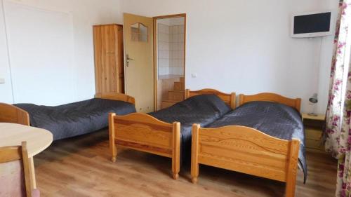 a bedroom with two beds and a table and a table at Gospodarstwo "Na Łęgach" in Lubcz Mały