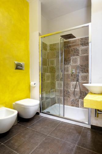 a bathroom with a shower and a toilet and a sink at Ziolì in Noto