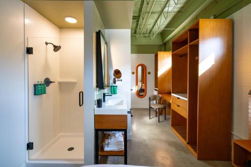 a bathroom with a tub and a sink and a shower at The Myriad Hotel Louisville, Tapestry Collection by Hilton in Louisville