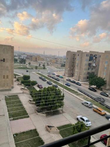 a view of a city street with cars and buildings at luxury apartment at Obour, 5th floor no elevator in Cairo