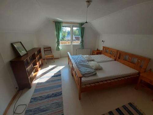 a bedroom with a large bed and a window at Hus uthyres i natursköna Glava, Arvika in Glava