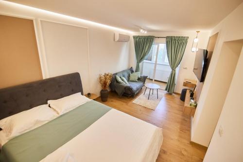 a bedroom with a bed and a living room at ChECk apartment in Focşani
