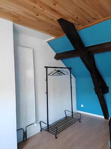 a room with a cross hanging from a ceiling at Une halte aux portes de Bourgoin in Saint-Marcel-Bel-Accueil