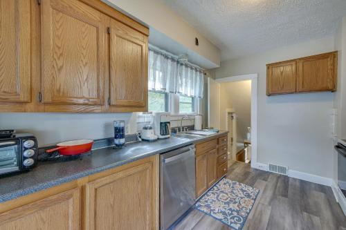 a kitchen with wooden cabinets and a counter top at Welcoming Home in Youngstown with Private Backyard! in Youngstown
