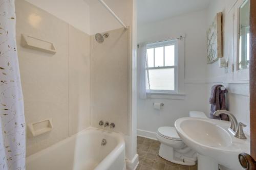 a white bathroom with a sink and a toilet at Welcoming Home in Youngstown with Private Backyard! in Youngstown