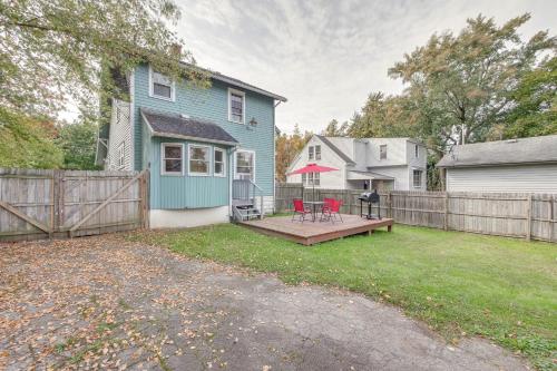 a yard with a wooden deck and a house at Welcoming Home in Youngstown with Private Backyard! in Youngstown
