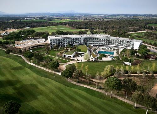 an aerial view of a building with a swimming pool at Camiral Golf & Wellness - Leading Hotel of the World in Caldes de Malavella