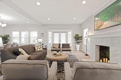 a living room with a couch and a fireplace at Mapleton - Workfriendly, football table, yard, free parking in Indianapolis