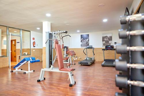 a gym with exercise equipment in a building at Zafiro Can Picafort in Can Picafort