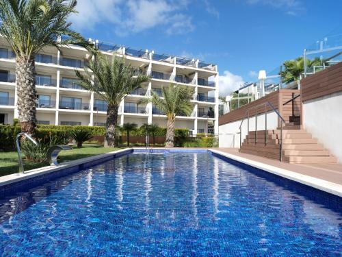 a swimming pool in front of a building at Zafiro Palace Palmanova in Palmanova