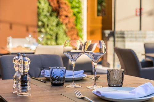 a wooden table with wine glasses and plates on it at Can Ribera by Zafiro in Muro