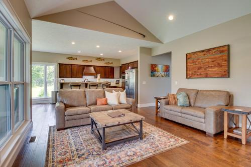 a living room with two couches and a table at Flippin Home with Deck and Grill Steps to White River in Flippin