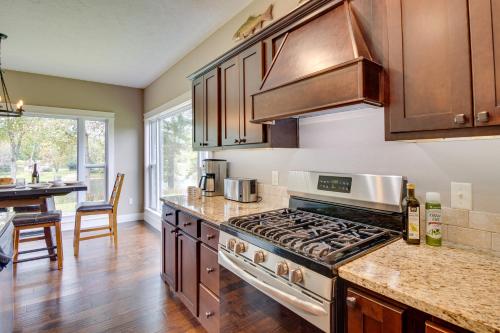 a kitchen with a stove and a counter top at Flippin Home with Deck and Grill Steps to White River in Flippin