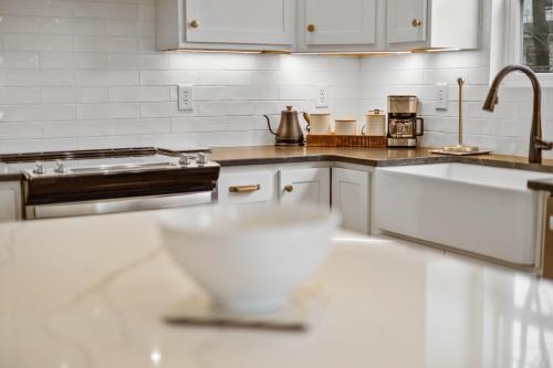 a kitchen with a sink and a bowl on a counter at Sunny & modern Derby house in Jeffersonville