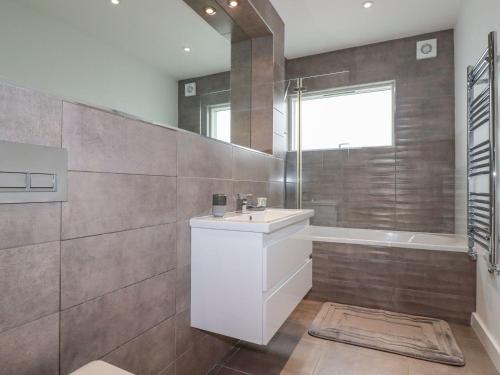 a bathroom with a white sink and a shower at 10 Quay Court in Newquay