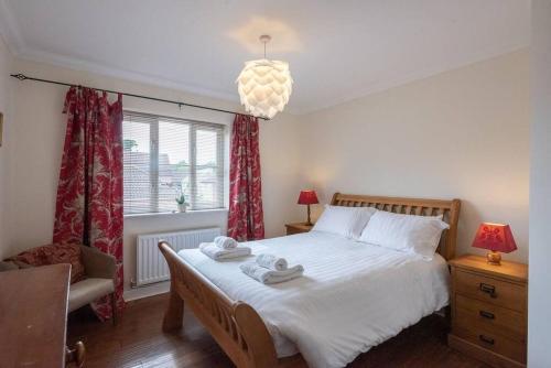 a bedroom with a bed with two towels on it at The Little Hopton, Saxmundham in Saxmundham