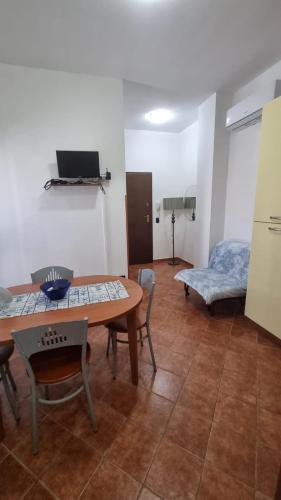 a room with a table and chairs and a bed at Le Residenze Blu Sardinia in La Caletta