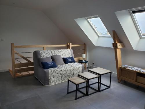 a living room with a couch and a bunk bed at Maison à 200m de la plage in Ploemeur
