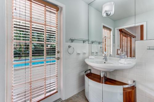 a bathroom with a sink and a mirror at Naples LaStrada - Private pool, 12 mins to beach in Naples