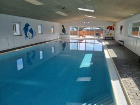 a large swimming pool in a large room at Nakskov Fjord Camping & Cottages in Nakskov