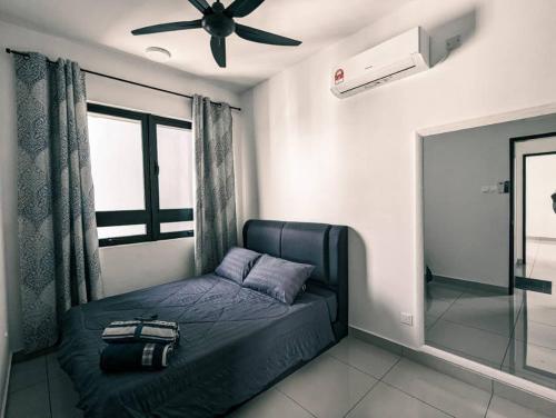 a bedroom with a bed and a ceiling fan at ReHut @ Setia Seraya by AzRaHomes in Putrajaya