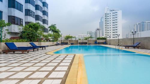 a swimming pool on the roof of a building at Omni Tower Sukhumvit Nana by Direct Rooms in Bangkok