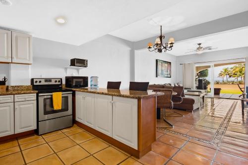a kitchen and living room with a stove top oven at Anclote 5103 in Punta Mita