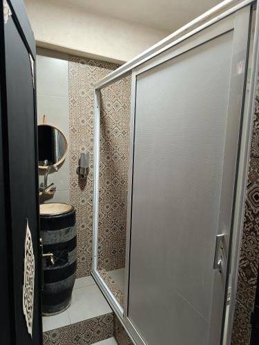 a bathroom with a shower with a toilet and a barrel at Be Nomad in Marrakech