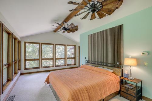 een slaapkamer met een groot bed en een kroonluchter bij Spacious Family Home in Lake Lure with Resort Perks! in Lake Lure