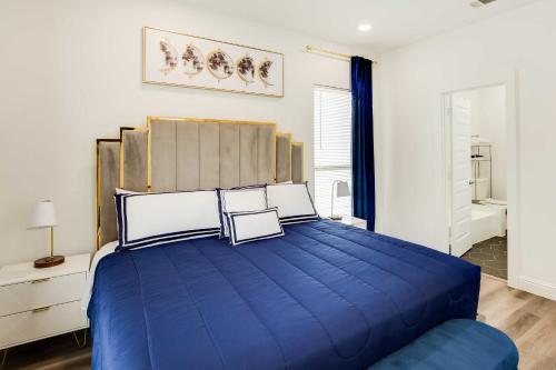 a bedroom with a large blue bed in a room at Chic and Spacious West Dallas Home Near Downtown! in Dallas
