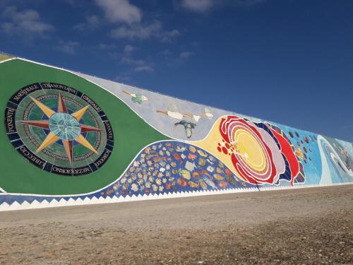 a mural on the side of a wall at Le Residenze Blu Sardinia in La Caletta