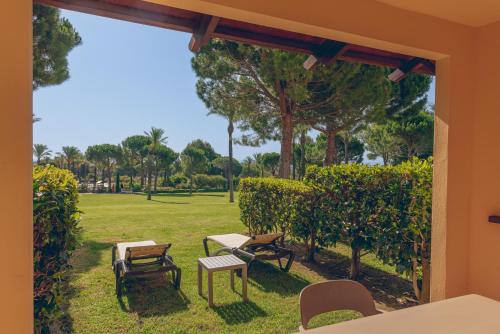 a view from a window of a park with tables and chairs at Pierre & Vacances Resort Bonavista de Bonmont in Montroig