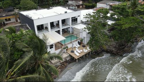 an aerial view of a house next to the water at Alpha Hotel Boutique in Necoclí