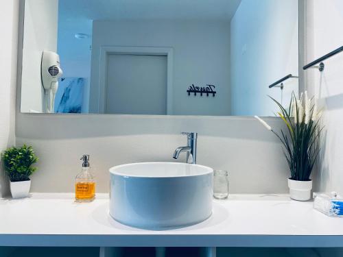 a bathroom with a sink and a mirror at A & S Vacation Rooms in Kissimmee