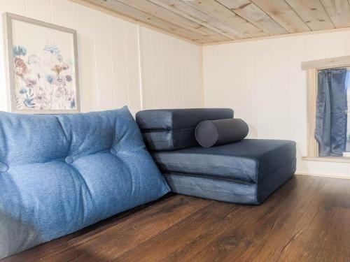a blue couch and a chair in a living room at The Little Park in Farmington