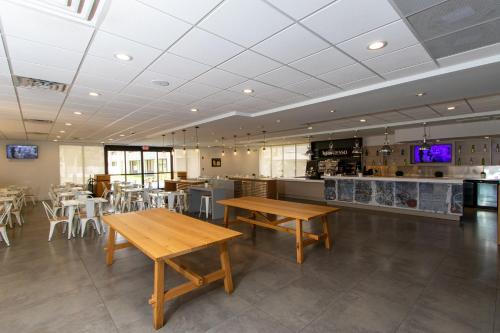a restaurant with tables and chairs and a counter at A & S Vacation Rooms in Kissimmee