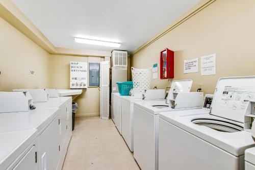 a laundry room with white washing machines and sinks at HH Beach & Tennis 322B in Hilton Head Island