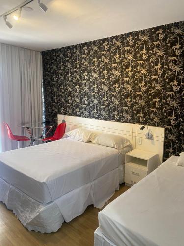 a hotel room with two beds and a wall mural at Garvey Park Hotel in Brasília