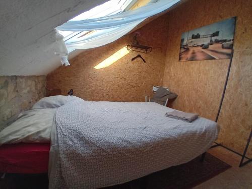 a bedroom with a bed in a room with a ceiling at Guesthouse Le petit chapeau in Durbuy