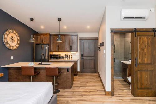 a kitchen with a bed and a kitchen with a counter at 22 Sunniva by FantasticStay in Fernie