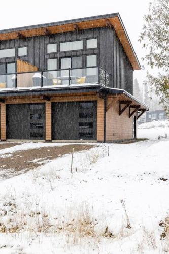a house with snow on the ground in front of it at 22 Sunniva by StayIn in Fernie