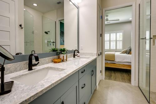 a bathroom with two sinks and a large mirror at Naples Retreat with Community Perks 6 Mi to Beach! in Naples