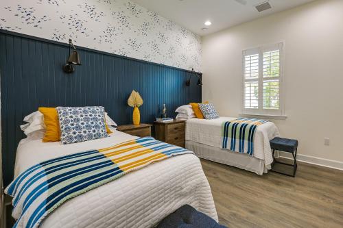a bedroom with two beds and a blue wall at Naples Retreat with Community Perks 6 Mi to Beach! in Naples