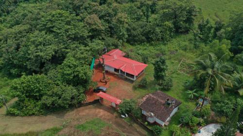 an overhead view of a house with a red roof at Cabo De Rama Cottage in Cola