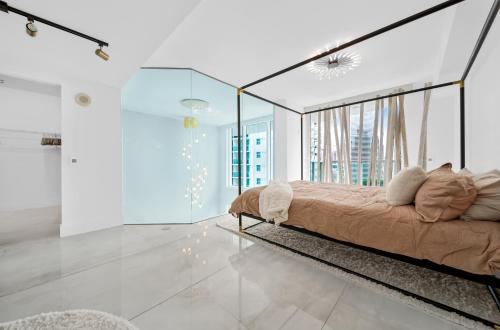 a bedroom with a bed and glass walls at Sunbeam Plush 2 Story Loft in Miami
