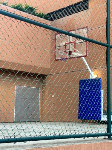 a chain link fence in front of a basketball hoop at Peak Suites At Times Square in Kuala Lumpur